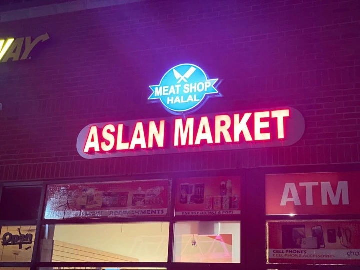 Aslan Market illuminated red channel letters at night