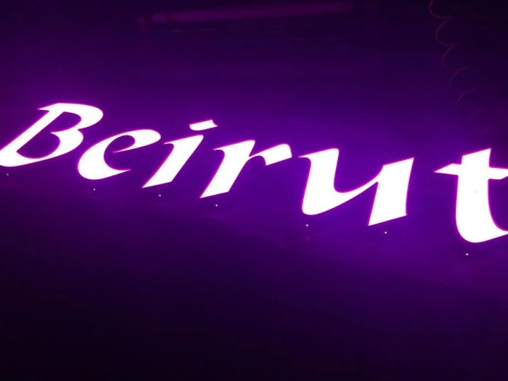 Beirut backlit script lettering glowing in magenta