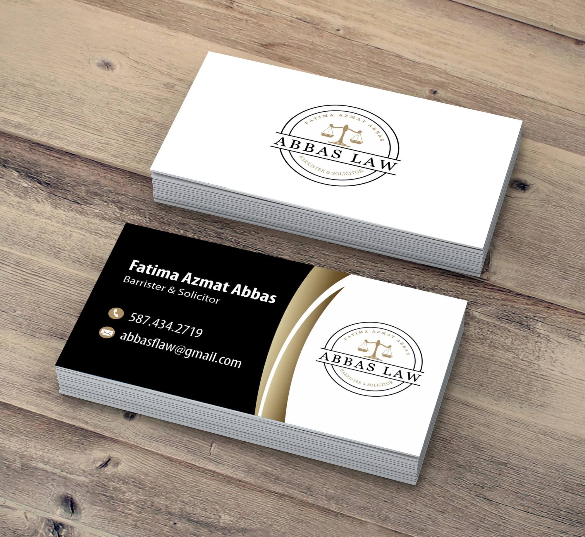 Abbas Law double sided business cards printed on a wood surface