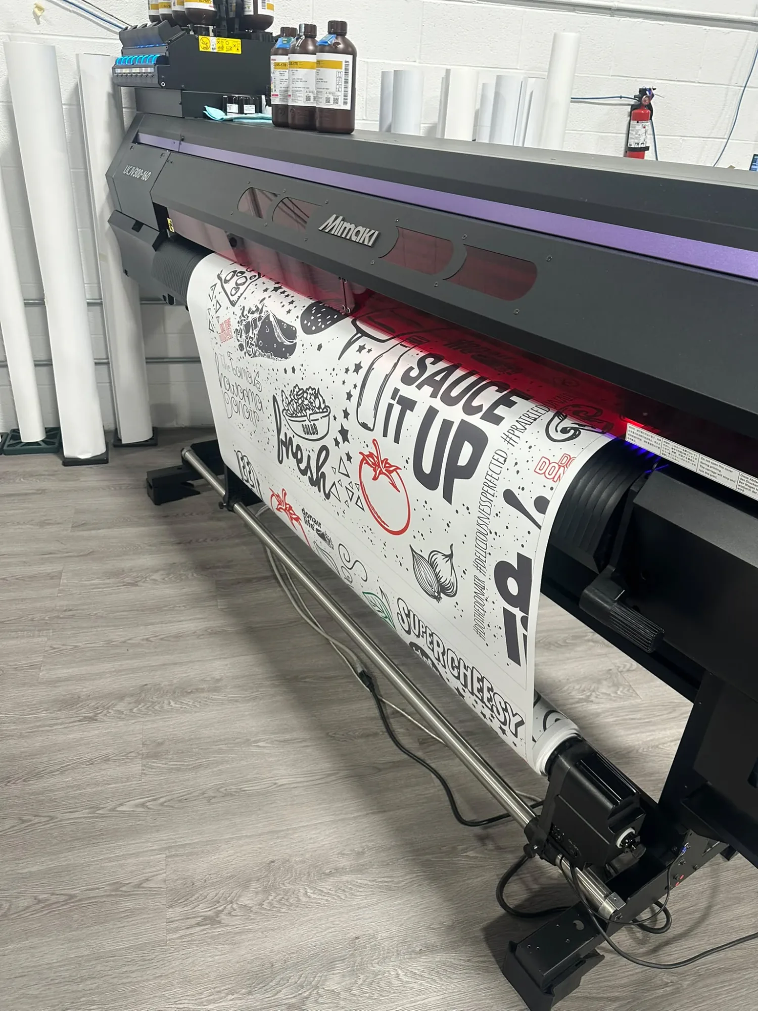 Wide format printer running a custom vinyl wall graphic in the Pal Signs shop