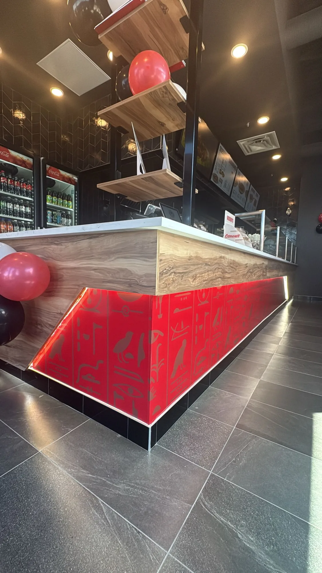 Backlit red counter front graphic with Egyptian hieroglyph print