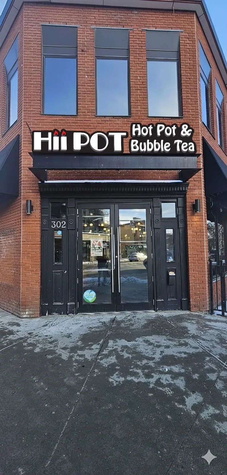 Hii Pot corner entrance signage on a red brick building