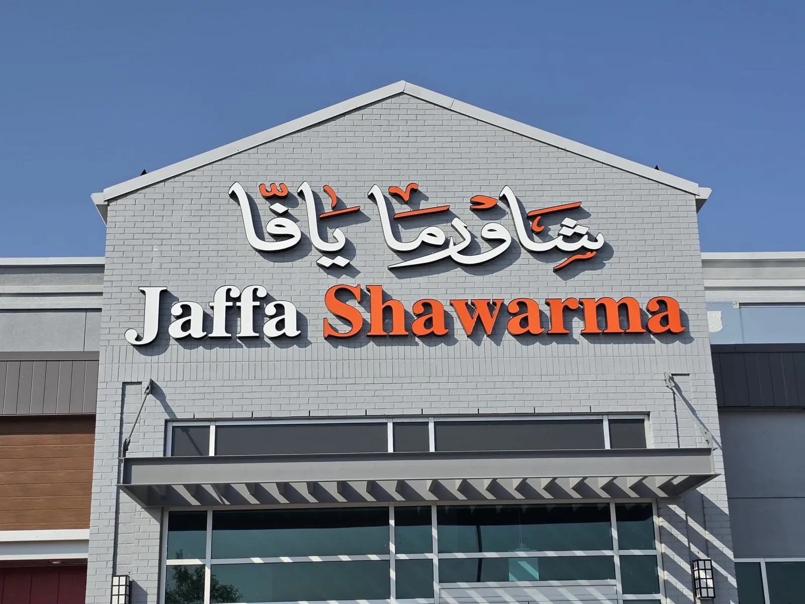 Jaffa Shawarma gable facade with Arabic calligraphy and channel letters in daylight