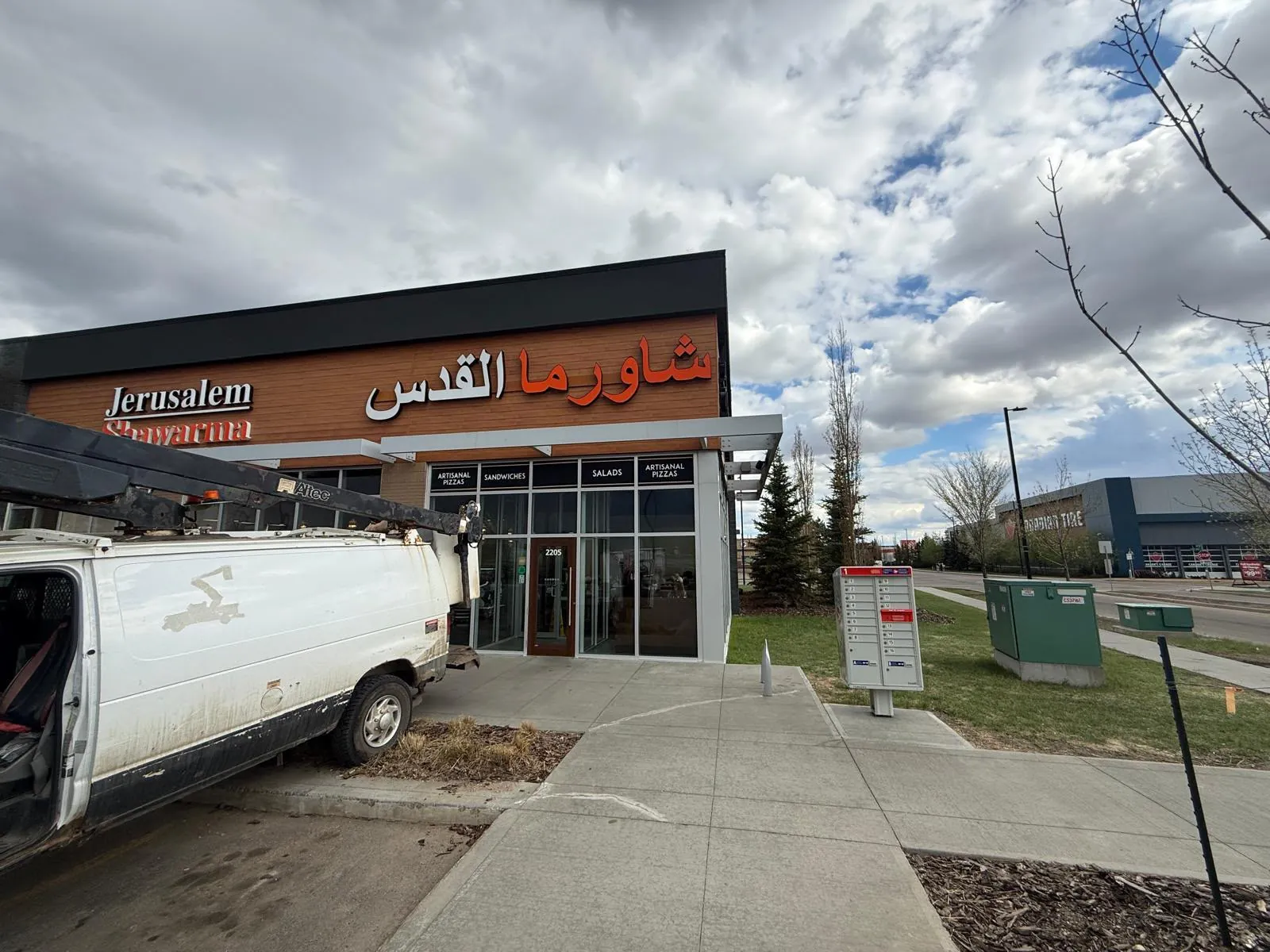 Jerusalem Shawarma storefront with Arabic Al Quds channel letters, install van out front