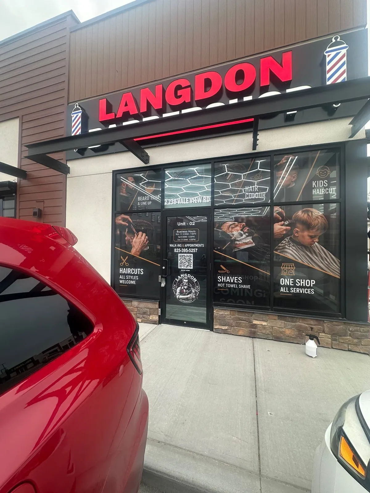 Langdon Barbershop window graphics with barbering photography across the glass