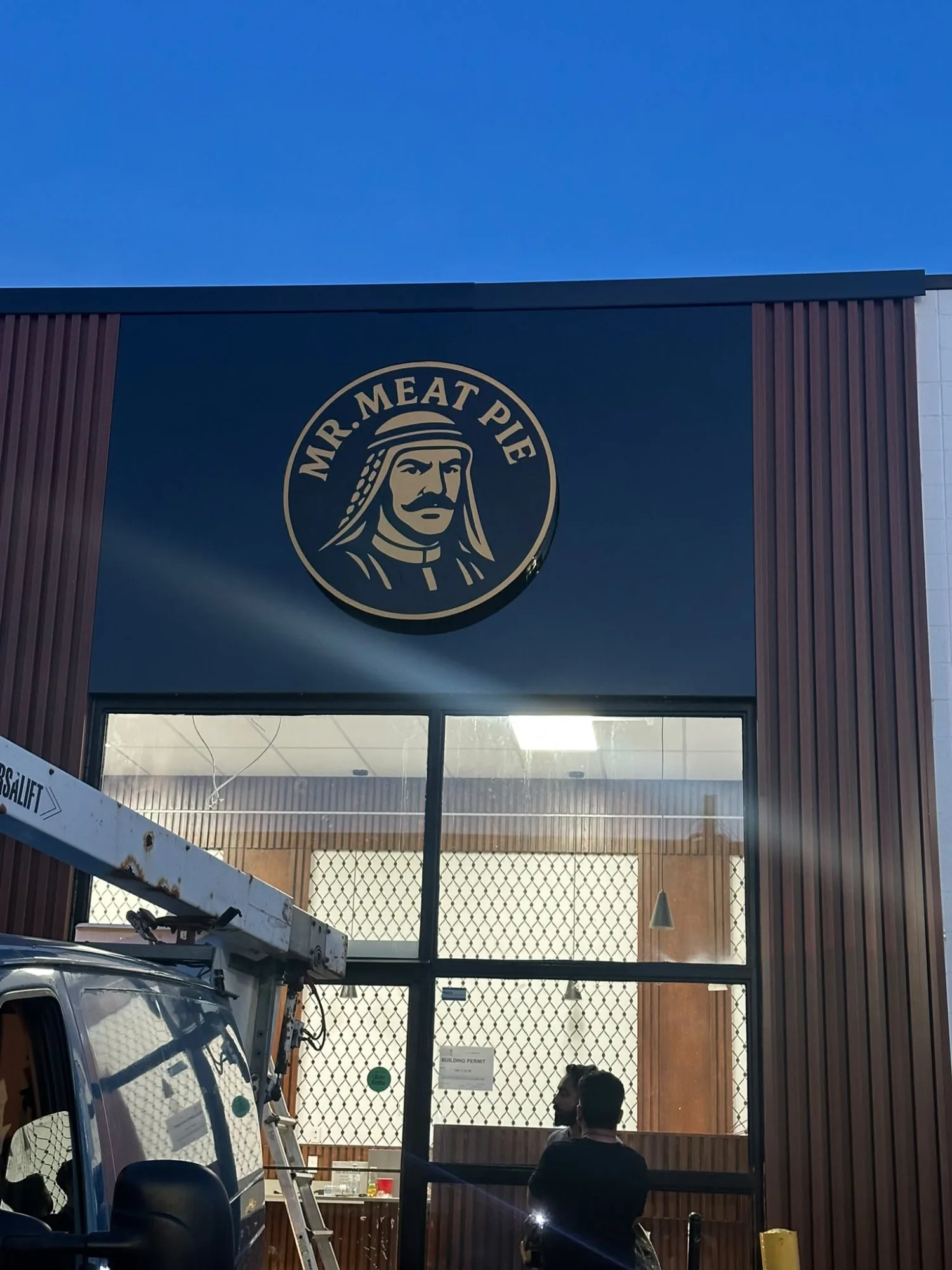 Mr. Meat Pie gold dimensional logo on black storefront fascia