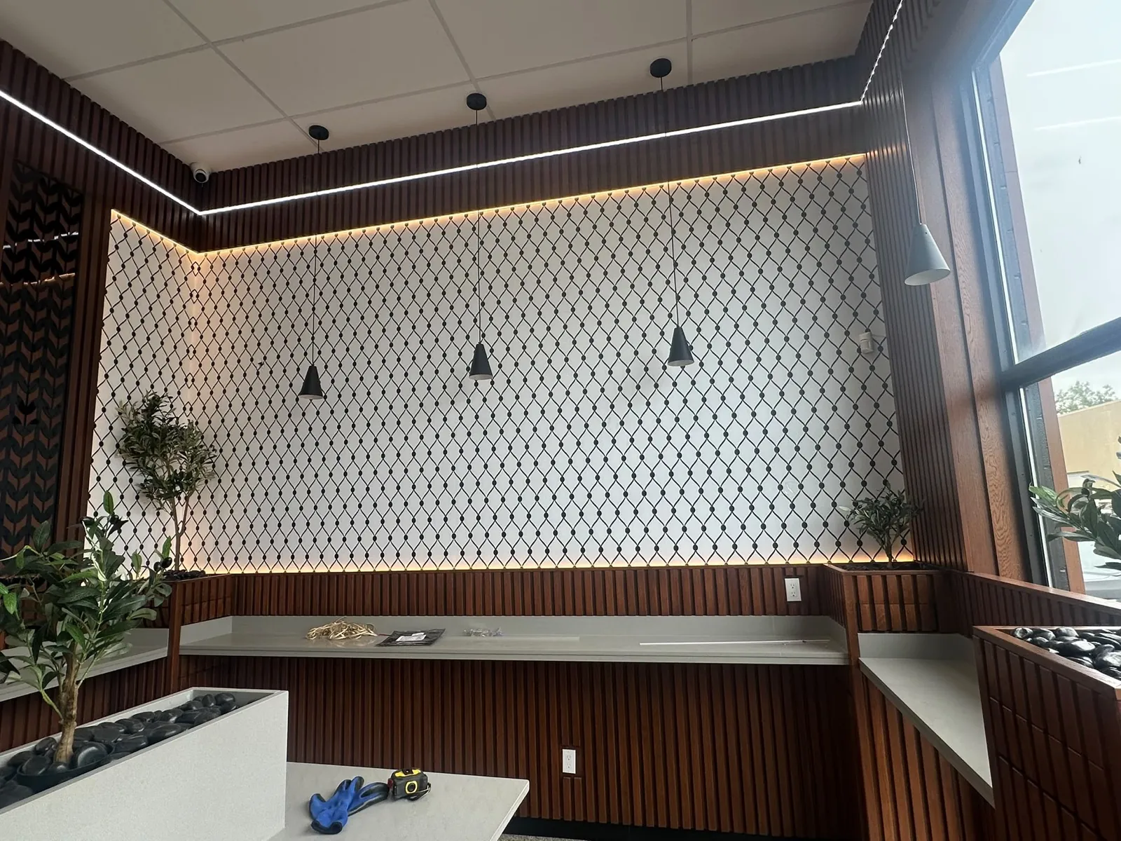 Mr. Meat Pie keffiyeh print feature wall with wood slats and pendant lighting