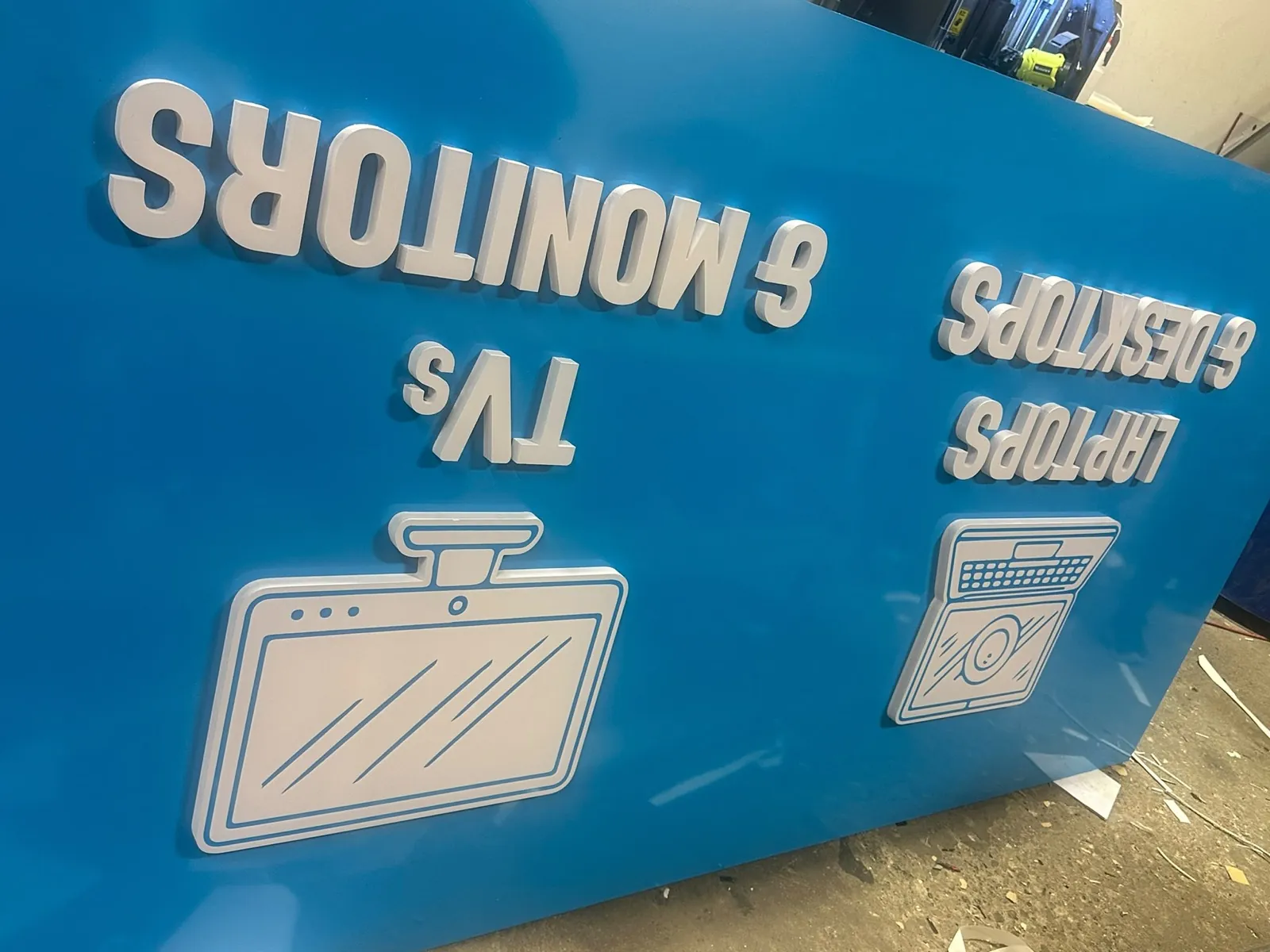 Blue Openbox wayfinding panel with white dimensional letters and icons in the shop