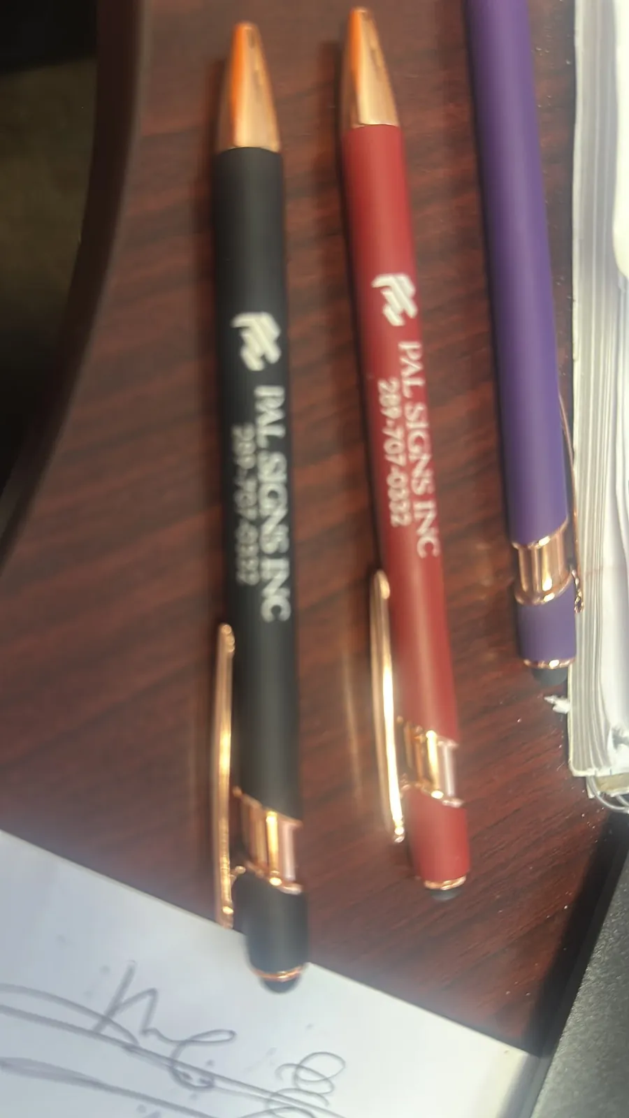 Pal Signs branded soft touch pens in black red and purple with rose gold trim