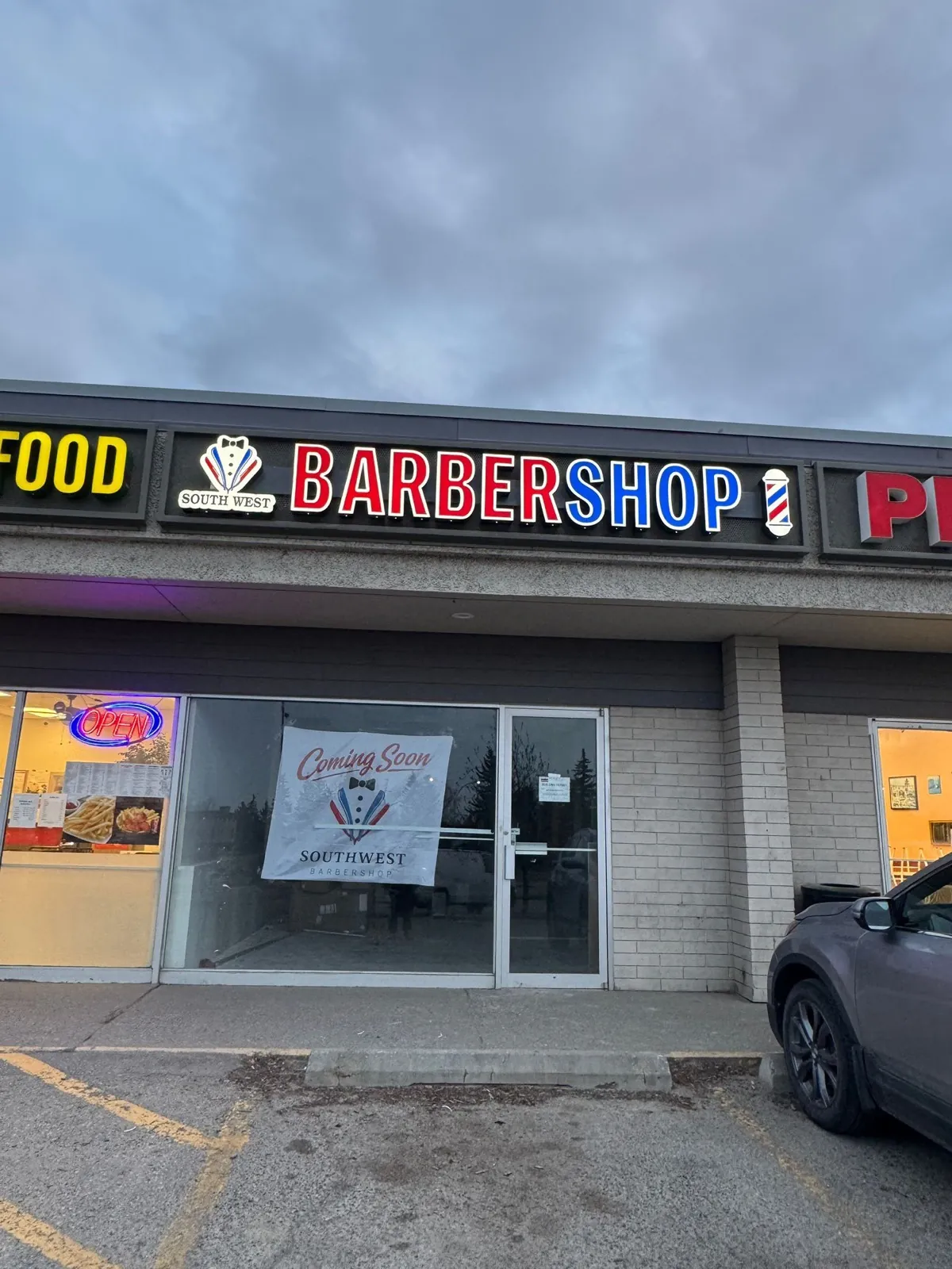 Southwest Barbershop red white and blue channel letters lit at dusk