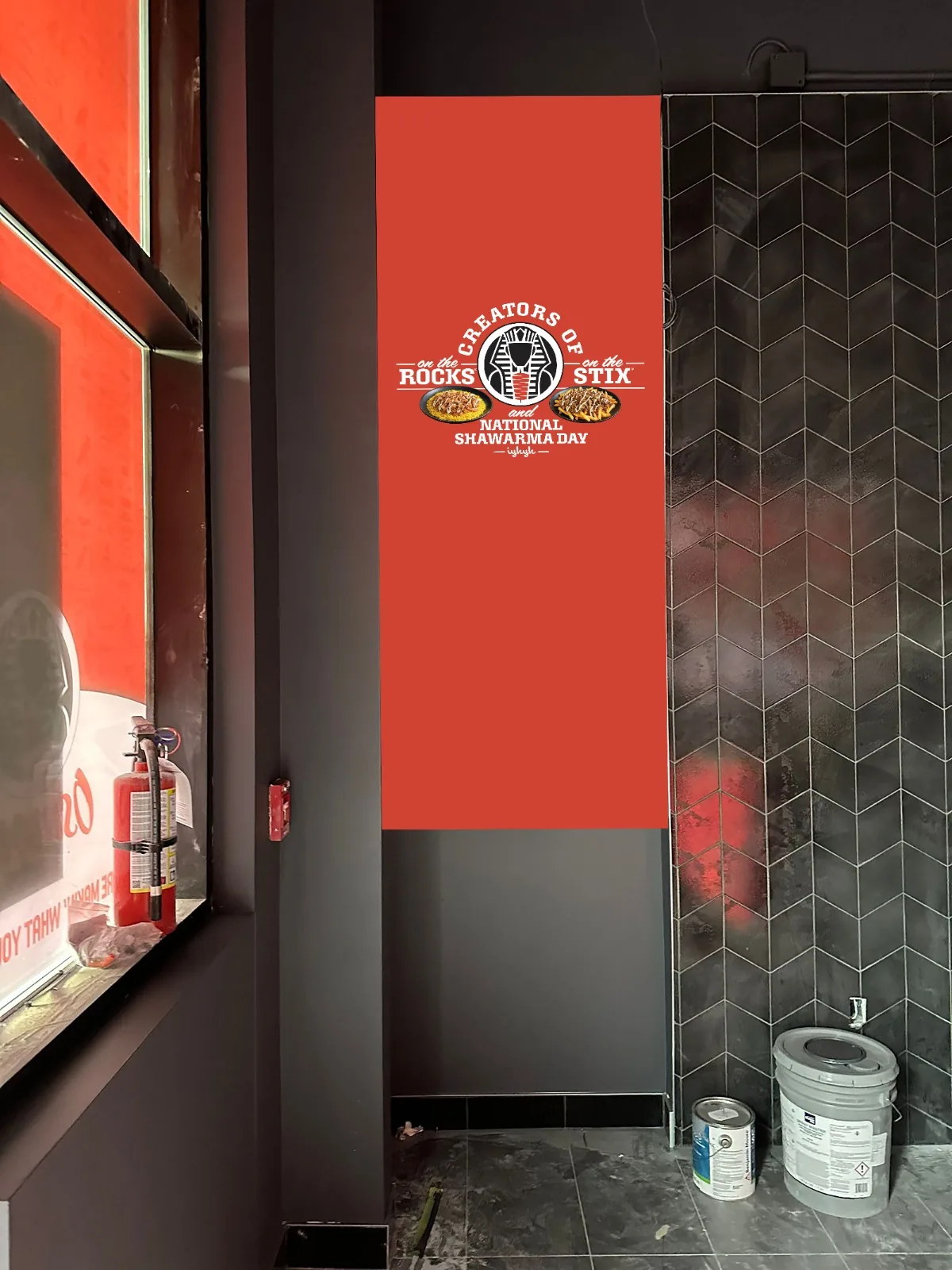 Red printed wall panel with Egyptian themed shawarma branding